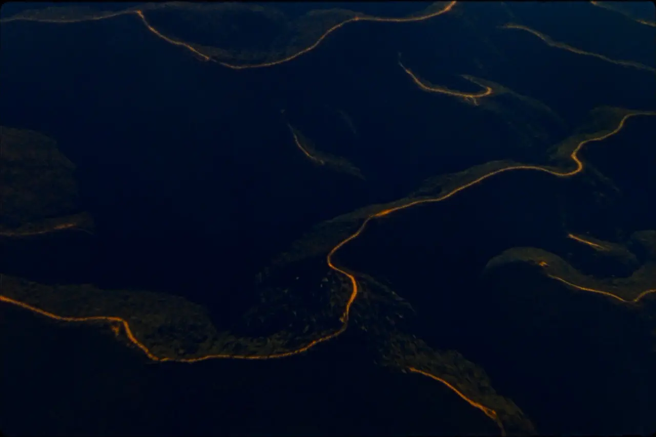Aerial view of highland ridges at dusk, last light tracing the contour lines